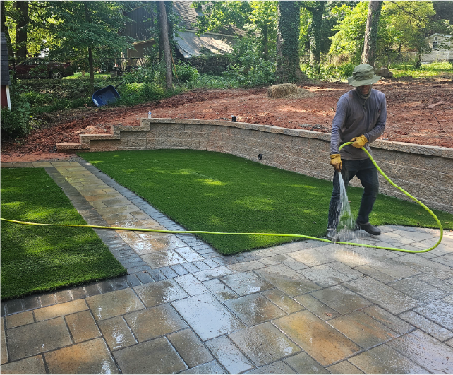 worker washing patio